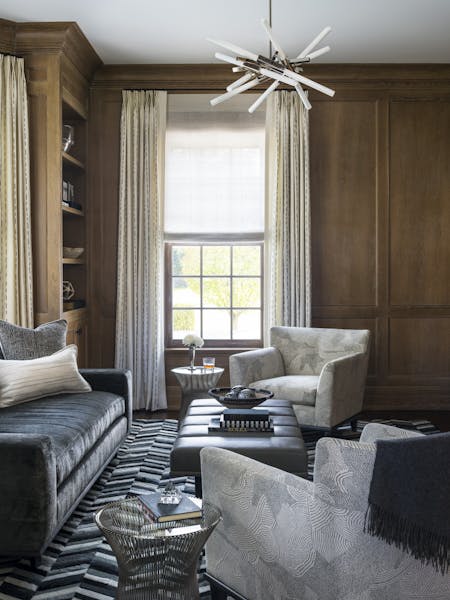 Elegant office space in a Manhattan study featuring a black-and-white color palette, velvet sofa, and cowhide rug, designed by K.A. Murphy Interiors