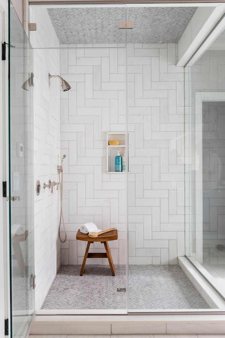 Luxurious shower area with custom tilework in a Long Island spa bathroom, designed by K.A. Murphy Interiors