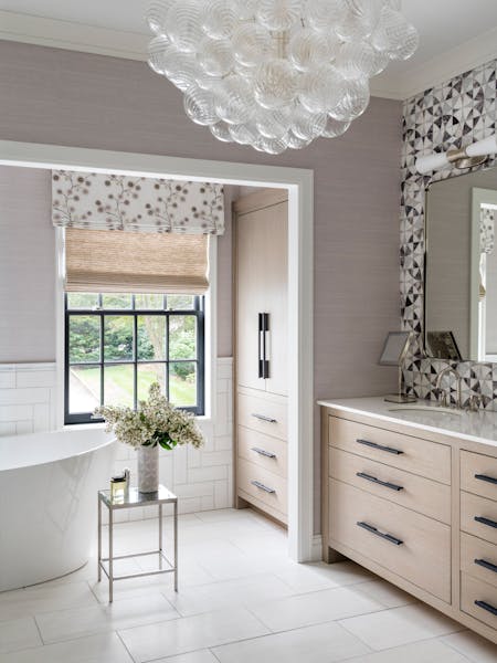 Elegant primary bathroom in a Long Island home featuring custom millwork, lilac marble, and waterjet mosaic stone, designed by K.A. Murphy Interiors.