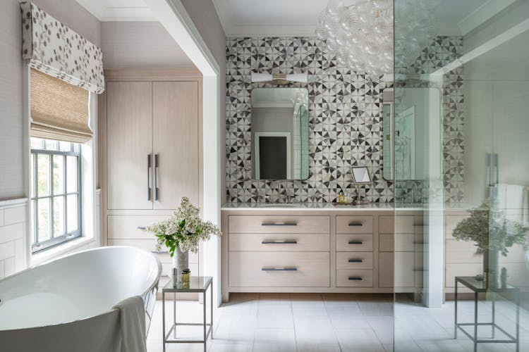 Elegant primary bathroom in a Long Island home featuring custom millwork, lilac marble, and waterjet mosaic stone, designed by K.A. Murphy Interiors.