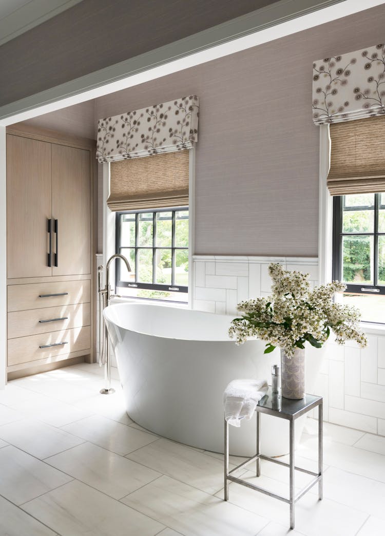 Close-up of a freestanding bathtub showcasing refined materials in a Long Island spa bathroom, designed by K.A. Murphy Interiors.