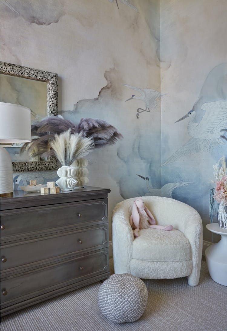 Comfortable corner chair with soft upholstery in a New York nursery, designed by K.A. Murphy Interiors