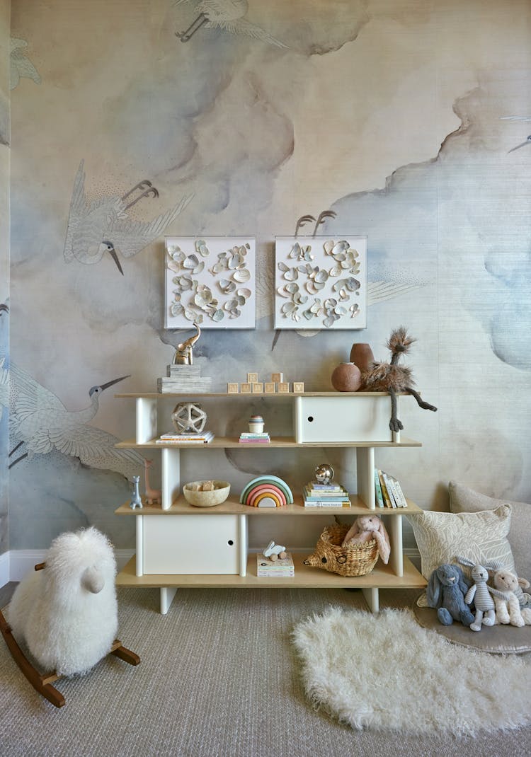 Organized toy shelf with curated toys in a Manhattan nursery, designed by K.A. Murphy Interiors