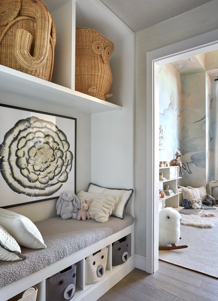 Functional storage bench for toys and essentials in a New York nursery, designed by K.A. Murphy Interiors.