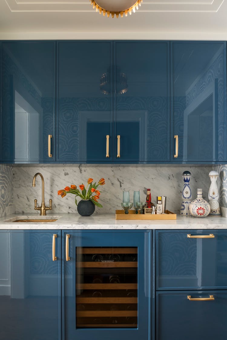 Stylish bar area with rich cabinetry in a Long Island family home, designed by K.A. Murphy Interiors