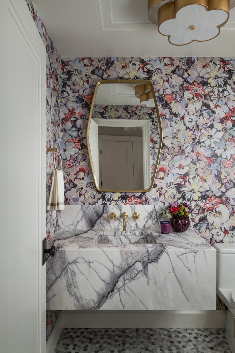 Elegant powder room with feminine design elements in a Long Island family home, designed by K.A. Murphy Interiors
