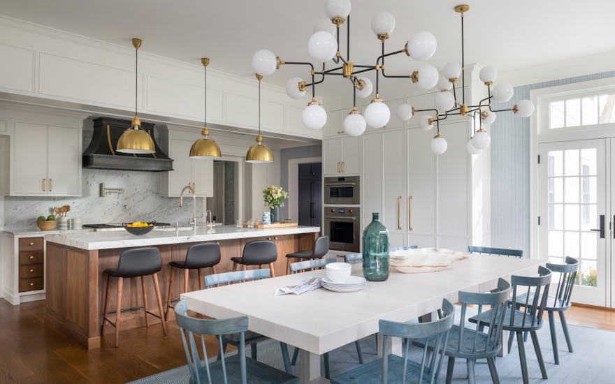 Open-concept kitchen transitioning into a spacious dining area in a Long Island family home, designed by K.A. Murphy Interiors