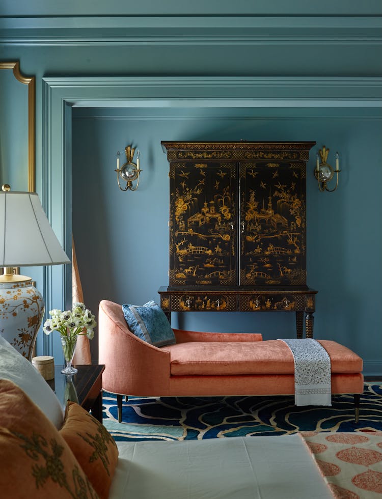 Elegant chaise lounge in the master bedroom of a Long Island Colonial Revival home, designed by K.A. Murphy Interiors
