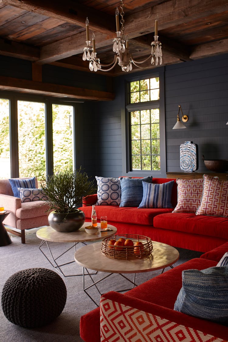 Stylish pool house interior in a Long Island Colonial Revival home featuring comfortable seating, natural light, and coastal-inspired design, designed by K.A. Murphy Interiors.