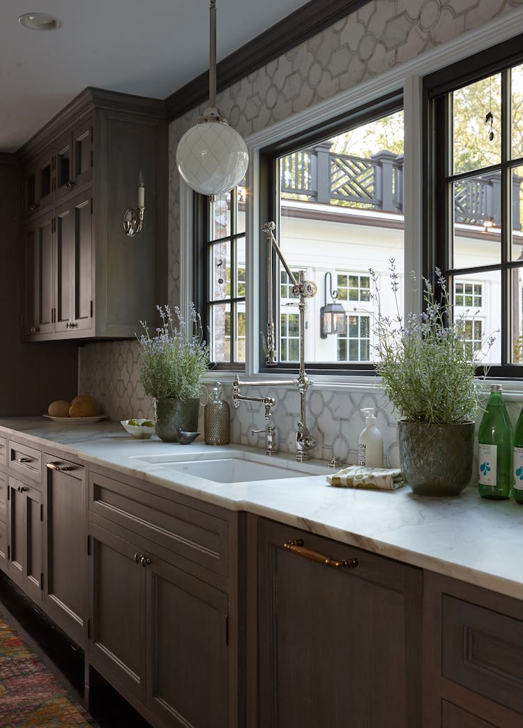 Elegant kitchen sink area in a Long Island Colonial Revival home with classic design and modern functionality, by K.A. Murphy Interiors