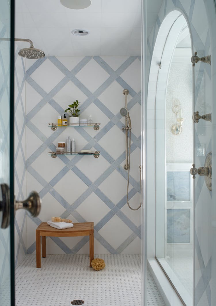 Functional bathroom bench in a Long Island Colonial Revival home, combining style and practicality, by K.A. Murphy Interiors