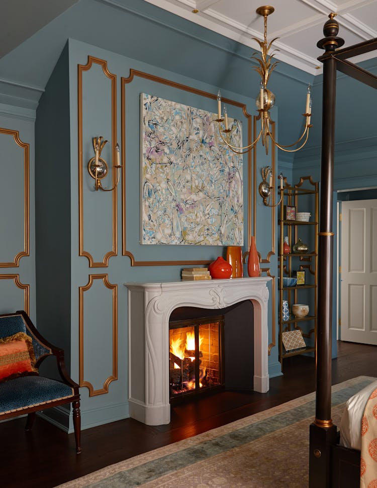 Classic fireplace in the master bedroom of a Long Island Colonial Revival home, adding warmth and charm, by K.A. Murphy Interiors