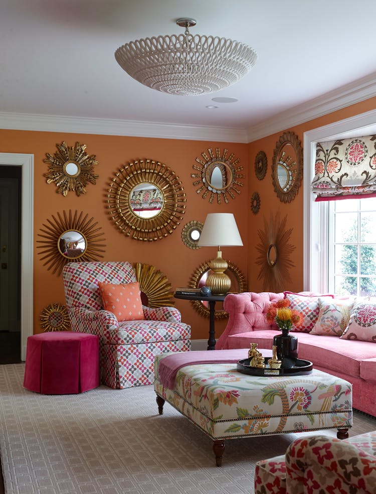 Vibrant pink and orange room in a Long Island Colonial Revival home, showcasing bold color choices and unique design elements, by K.A. Murphy Interiors