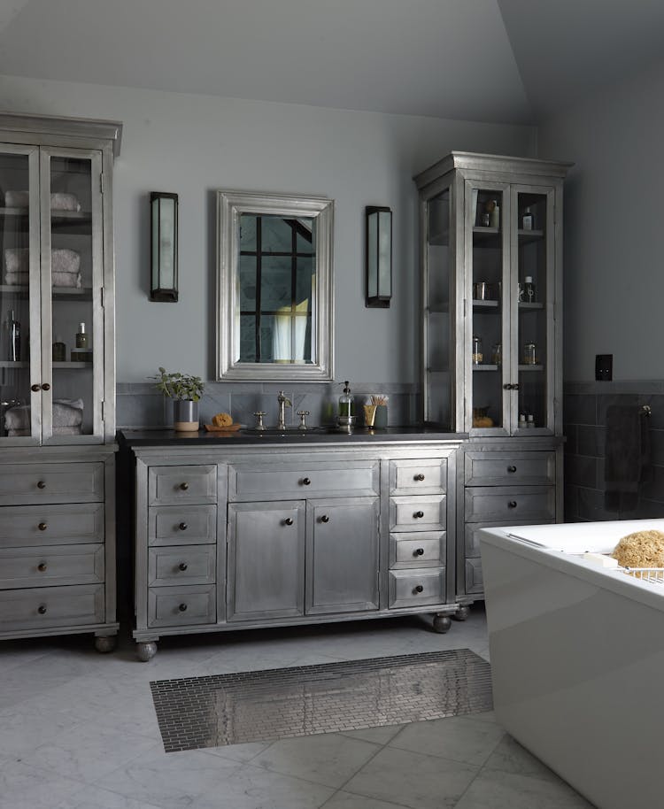 Bright and functional bathroom in a Long Island Colonial Revival home with modern fixtures and classic design touches, designed by K.A. Murphy Interiors
