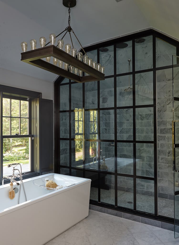 Bright and functional bathroom in a Long Island Colonial Revival home with modern fixtures and classic design touches, designed by K.A. Murphy Interiors