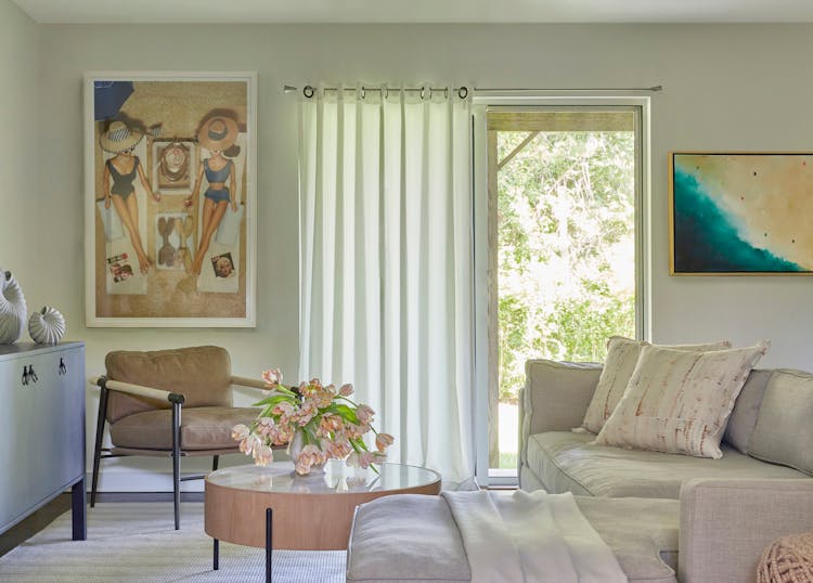 Spacious family room in a Montauk retreat showcasing colorful artwork and comfortable seating, designed by K.A. Murphy Interiors.