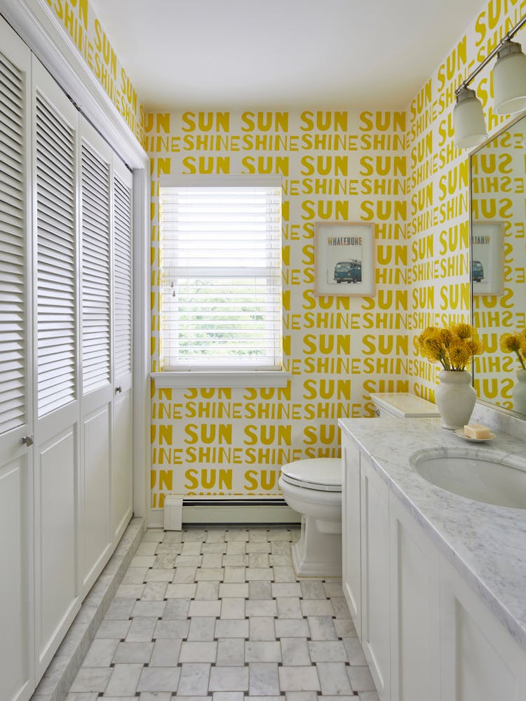 Elegant half bathroom in a Montauk beach house featuring modern fixtures and coastal design elements, by K.A. Murphy Interiors