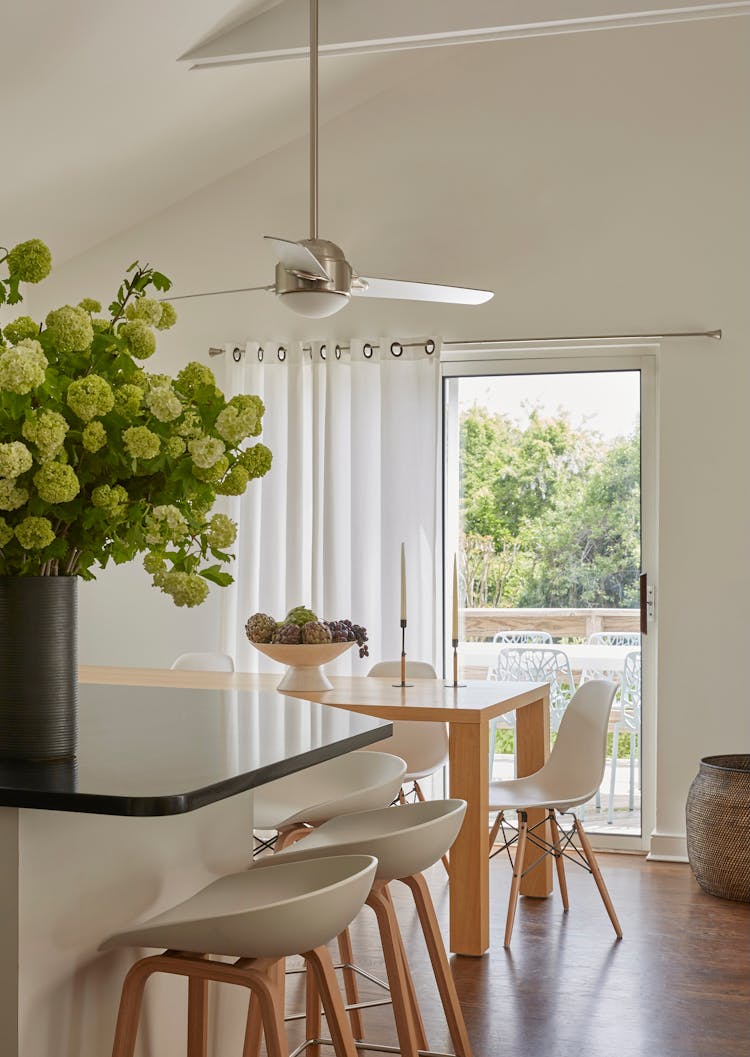Contemporary kitchen in a Montauk retreat with glass doors opening to outdoor spaces, designed by K.A. Murphy Interiors.