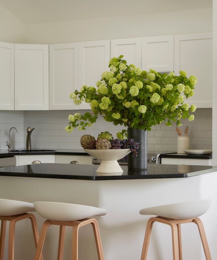 Sleek kitchen island in a Montauk beach house, serving as a central gathering spot, designed by K.A. Murphy Interiors