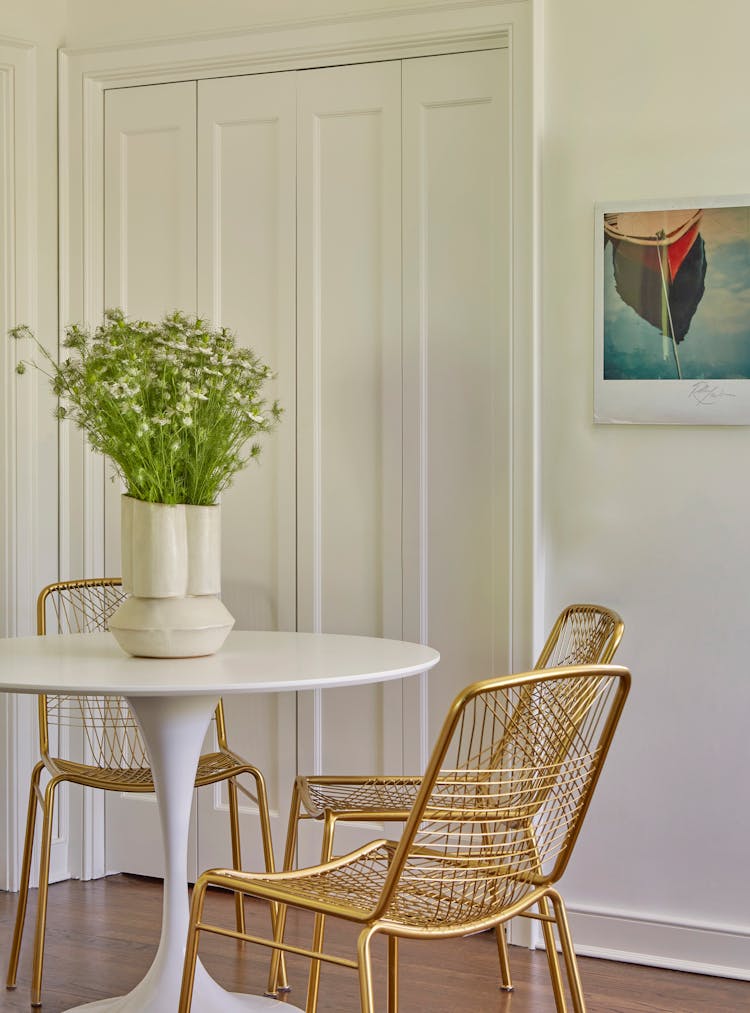 Elegant round dining table in a Montauk retreat, perfect for family meals, designed by K.A. Murphy Interiors