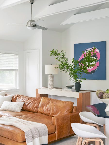 Bright and airy living room in a Montauk beach house featuring vibrant pop art and coastal-inspired decor, designed by K.A. Murphy Interiors