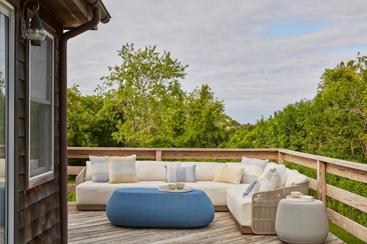 Full view of patio area in a Montauk retreat showcasing comfortable seating and coastal surroundings, designed by K.A. Murphy Interiors