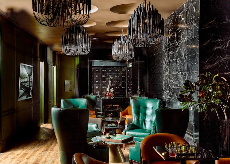 Elegant lounge chairs with green leather upholstery in a Lower Manhattan gentleman’s lounge, designed by K.A. Murphy Interiors