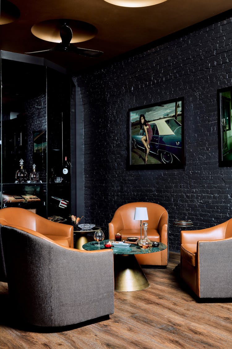Lounge chair paired with a brass and marble table in a Lower Manhattan gentleman’s lounge, designed by K.A. Murphy Interiors