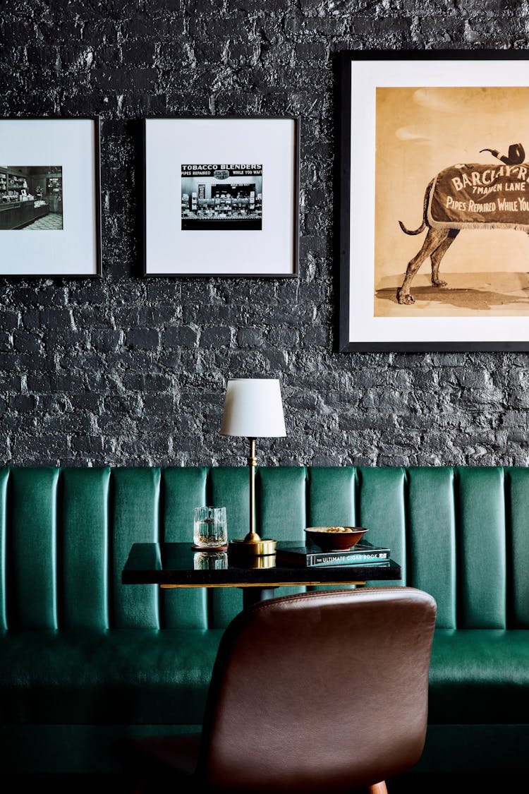 Stylish booth table with a brass base and marble top in a Lower Manhattan gentleman’s lounge, designed by K.A. Murphy Interiors