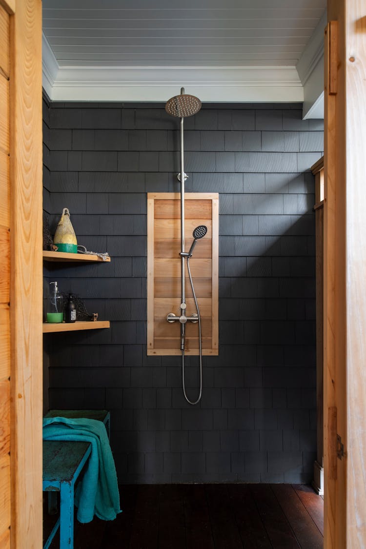 Refreshing outdoor shower in a Long Island coastal retreat using natural materials by K.A. Murphy Interiors