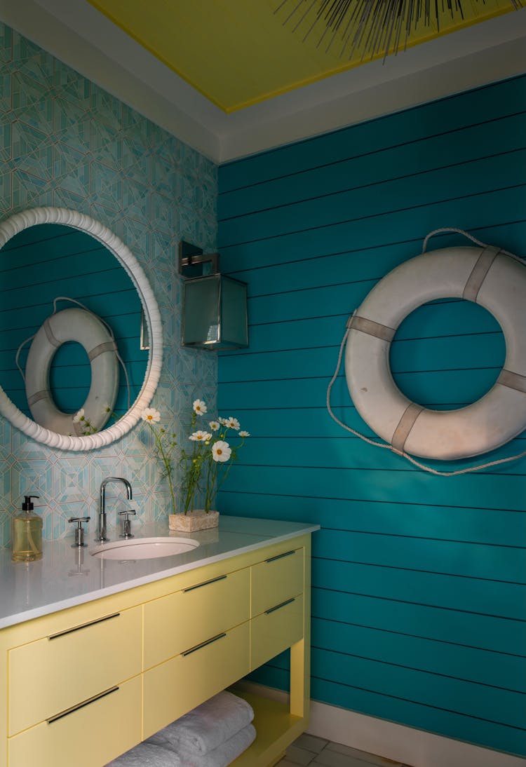 Convenient poolside bathroom in a Long Island luxury coastal home by K.A. Murphy Interiors