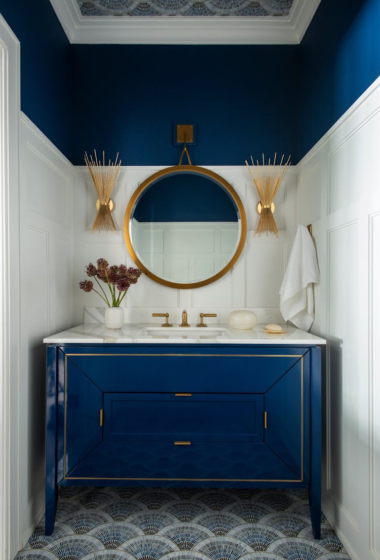 Elegant powder room in a Long Island luxury retreat featuring refined fixtures by K.A. Murphy Interiors
