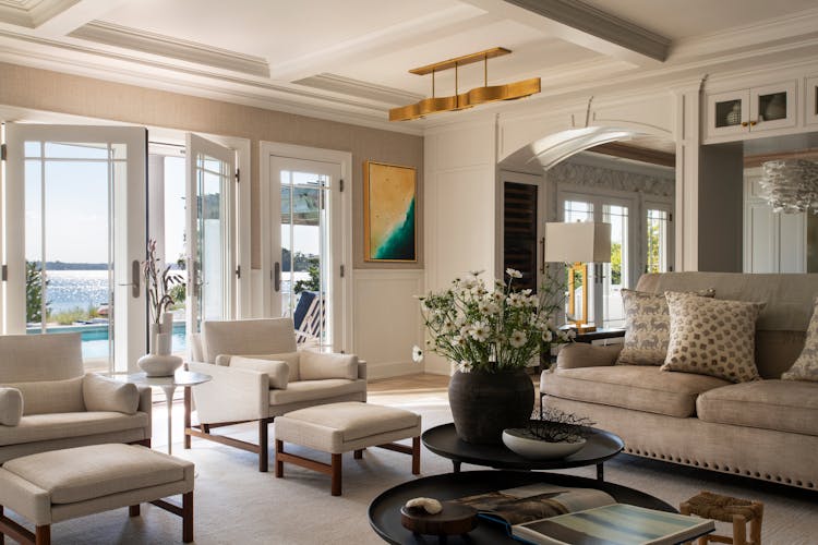 Spacious family room with expansive windows and doors in Long Island, offering natural light and indoor-outdoor flow, designed by K.A. Murphy Interiors.