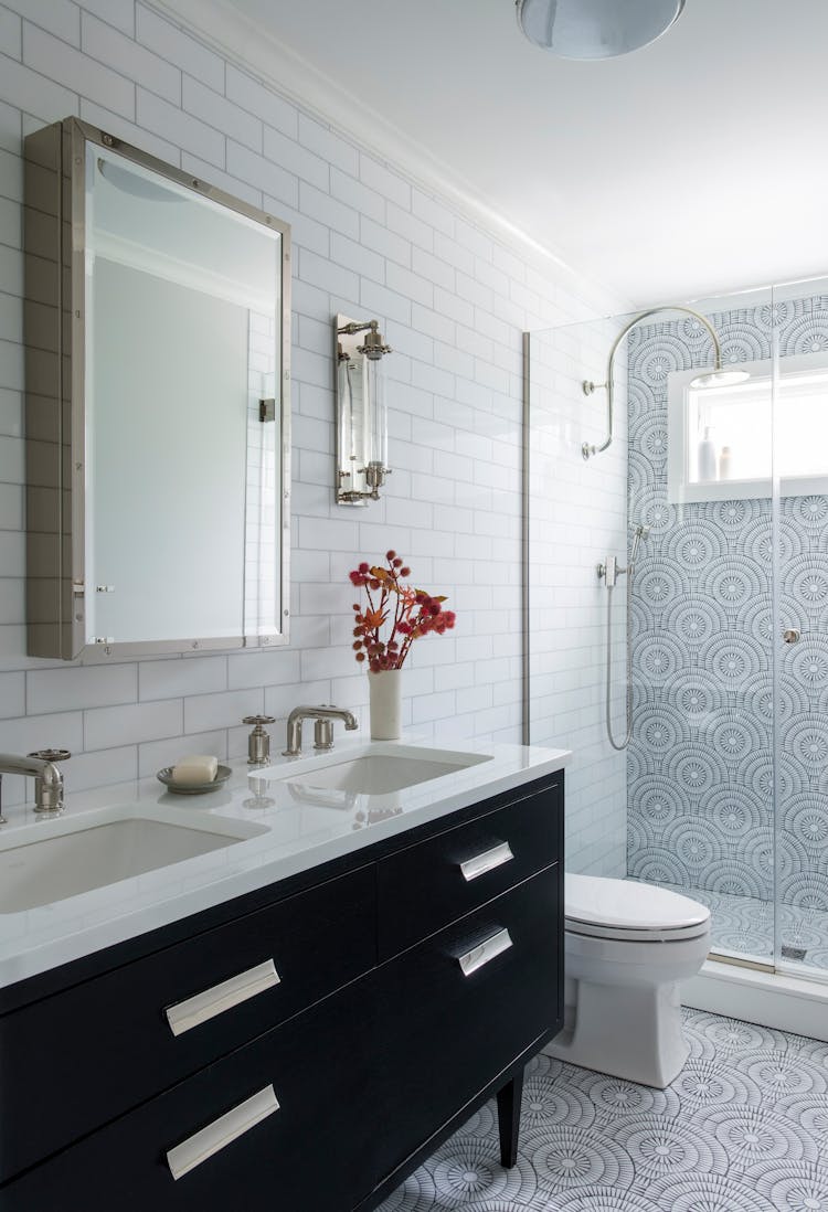 Stylish guest bathroom in a Long Island coastal home with elegant fixtures by K.A. Murphy Interiors.