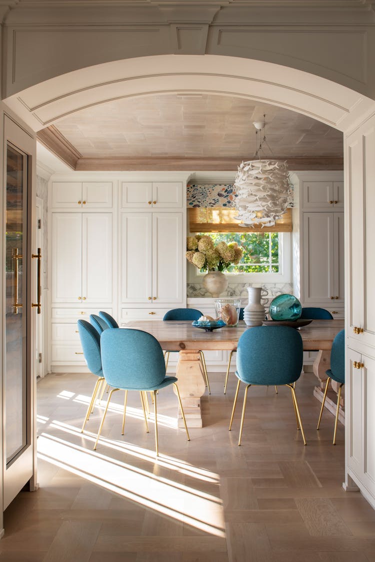 Architectural archway leading into the kitchen of a Long Island luxury coastal home by K.A. Murphy Interiors