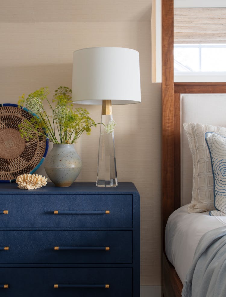 Stylish bedside vignette in a Long Island luxury coastal bedroom with curated decor by K.A. Murphy Interiors