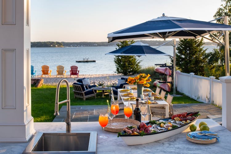 Spacious outdoor area in a Long Island luxury coastal home for alfresco dining and gatherings by K.A. Murphy Interiors