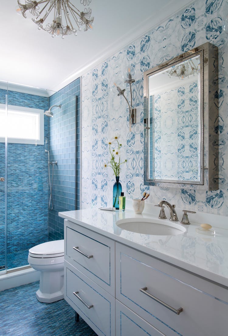 Modern guest bathroom in a Long Island coastal retreat featuring contemporary fixtures by K.A. Murphy Interiors.