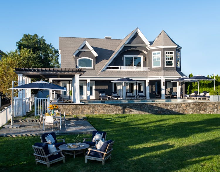 Rear exterior of a Long Island luxury coastal home with expansive windows by K.A. Murphy Interiors