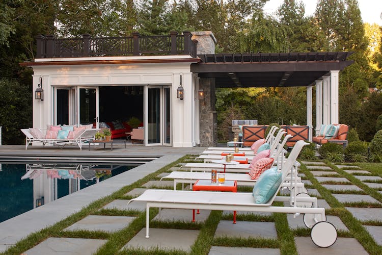 Inviting patio with outdoor seating in a Long Island Colonial Revival home, designed for entertaining and relaxation, by K.A. Murphy Interiors