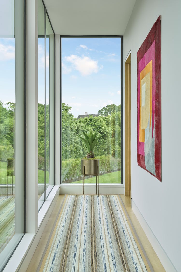 Abstract rug adding a pop of color to the foyer of a Hamptons show house, designed by K.A. Murphy Interiors