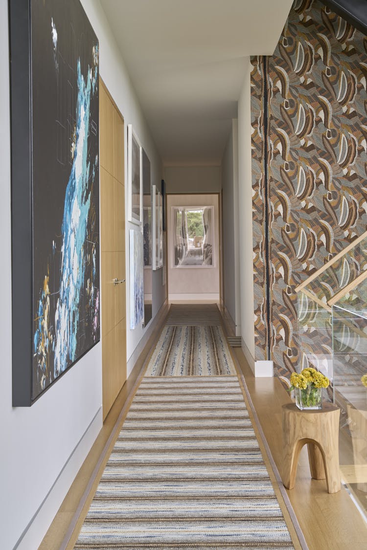 Abstract rug adding a pop of color to the foyer of a Hamptons show house, designed by K.A. Murphy Interiors
