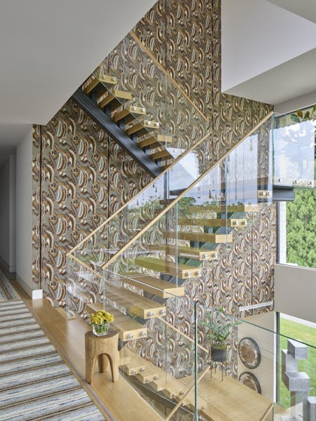 Elegant foyer in a Hamptons show house, featuring earthen tones and layered textures, designed by K.A. Murphy Interiors