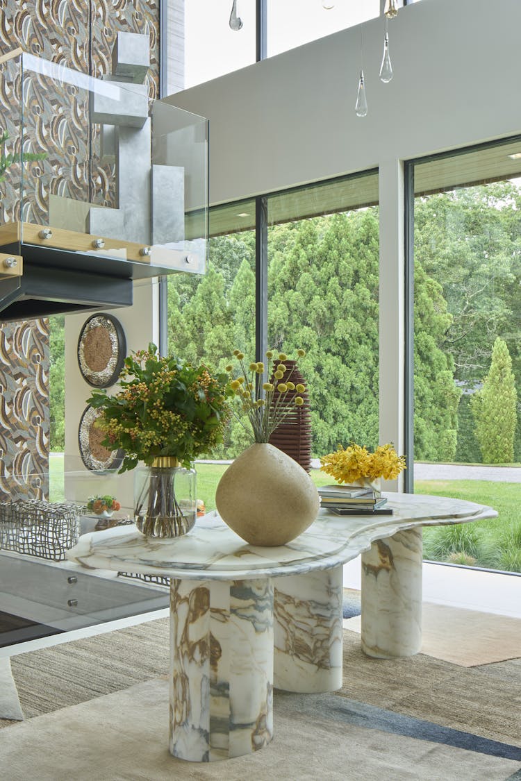 Elegant foyer in a Hamptons show house, featuring earthen tones and layered textures, designed by K.A. Murphy Interiors