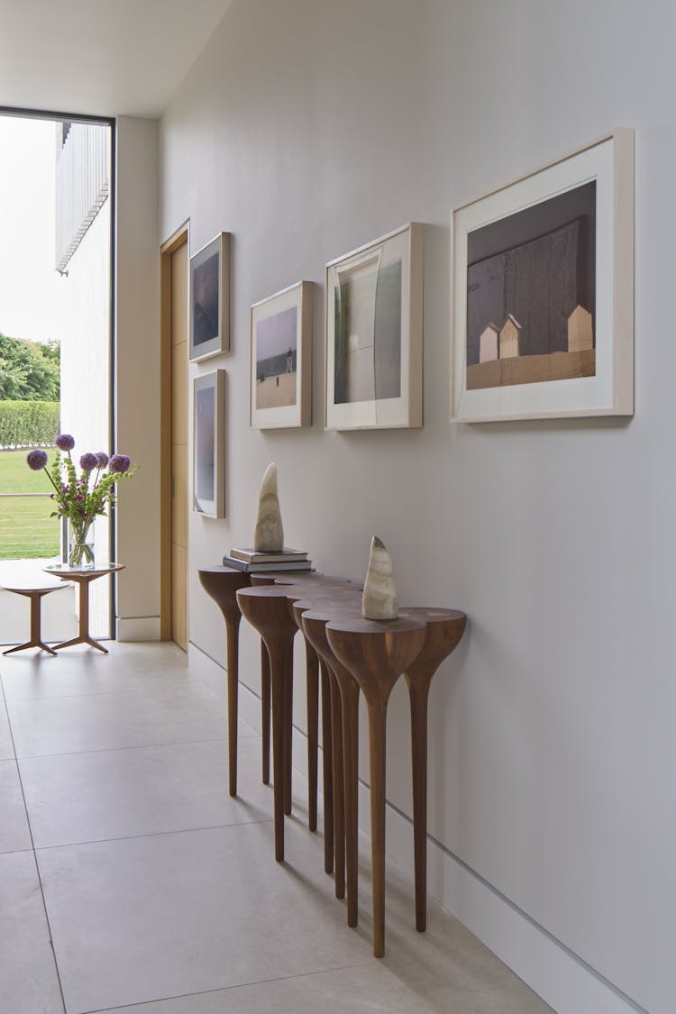 Sculptural furniture pieces enhancing the foyer of a Hamptons show house, designed by K.A. Murphy Interiors.
