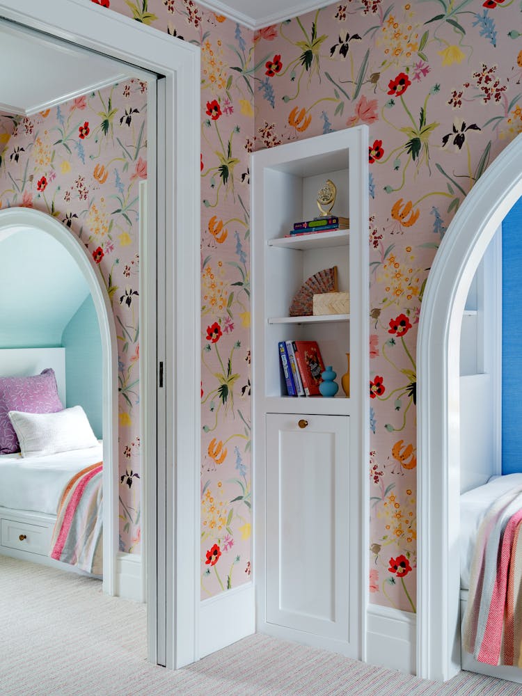 Translucent dividing door separating twin bed alcoves in a Manhasset children's bedroom, designed by K.A. Murphy Interiors.
