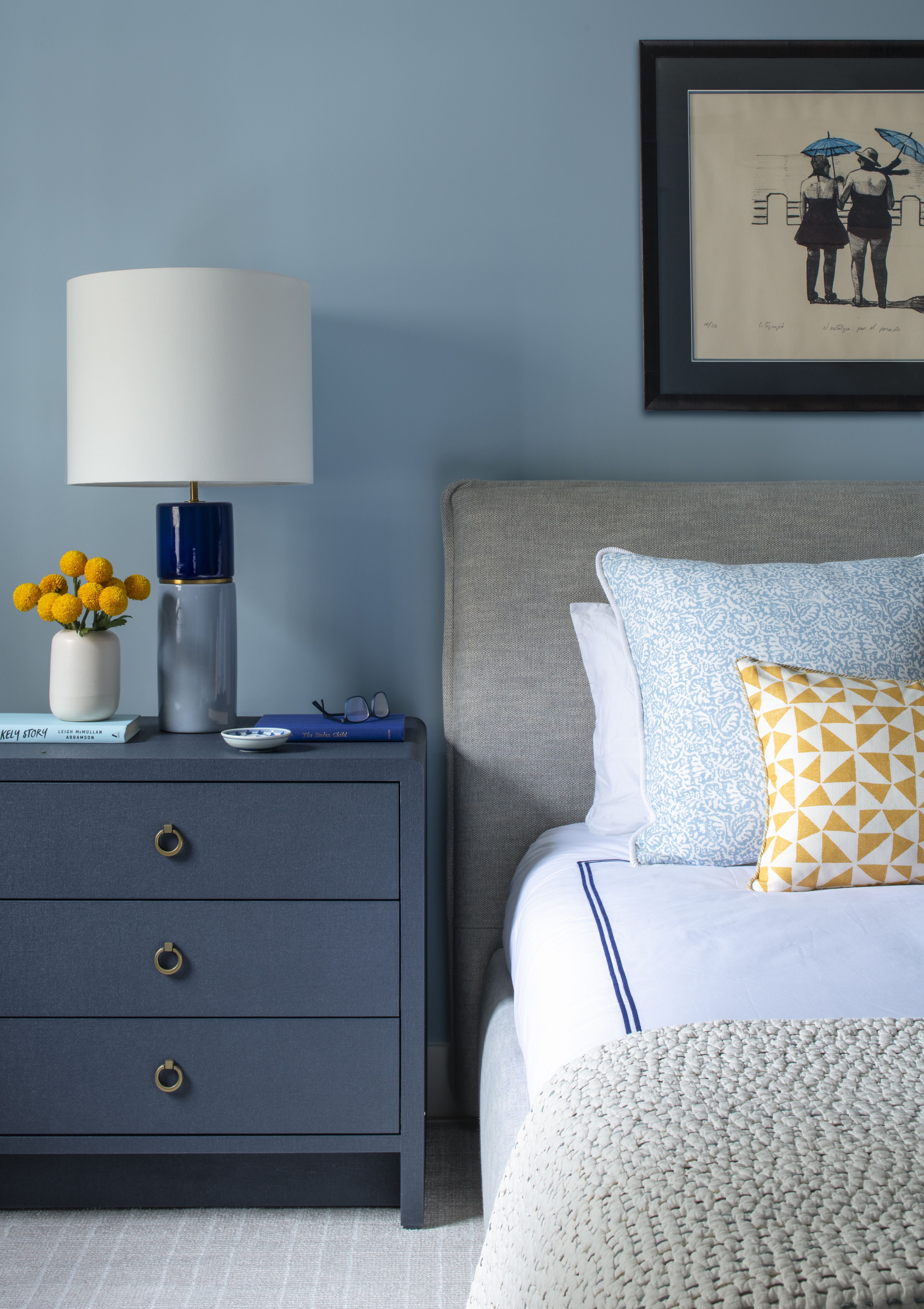 Guest bedroom vignette showcasing a tailored nightstand, layered pillows, and blue-and-white palette by K.A. Murphy Interiors.