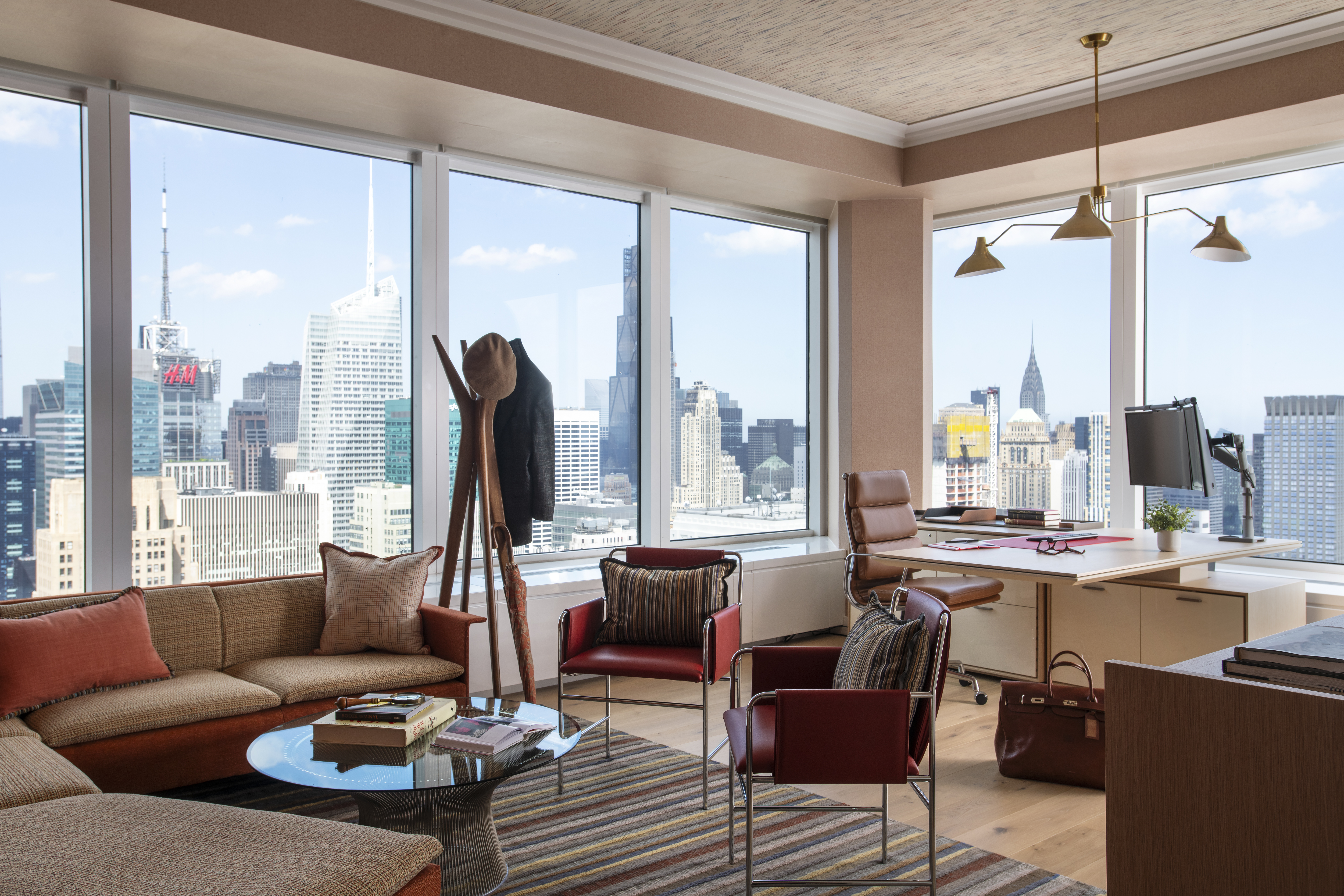Luxury executive office at One Penn Plaza designed by K.A. Murphy Interiors with custom furnishings, contemporary lighting, and expansive New York City skyline views.