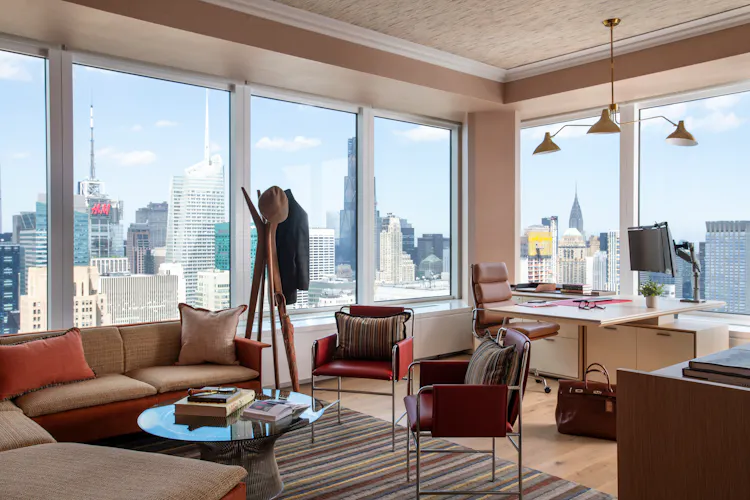 Luxury executive office at One Penn Plaza designed by K.A. Murphy Interiors with custom furnishings, contemporary lighting, and expansive New York City skyline views.