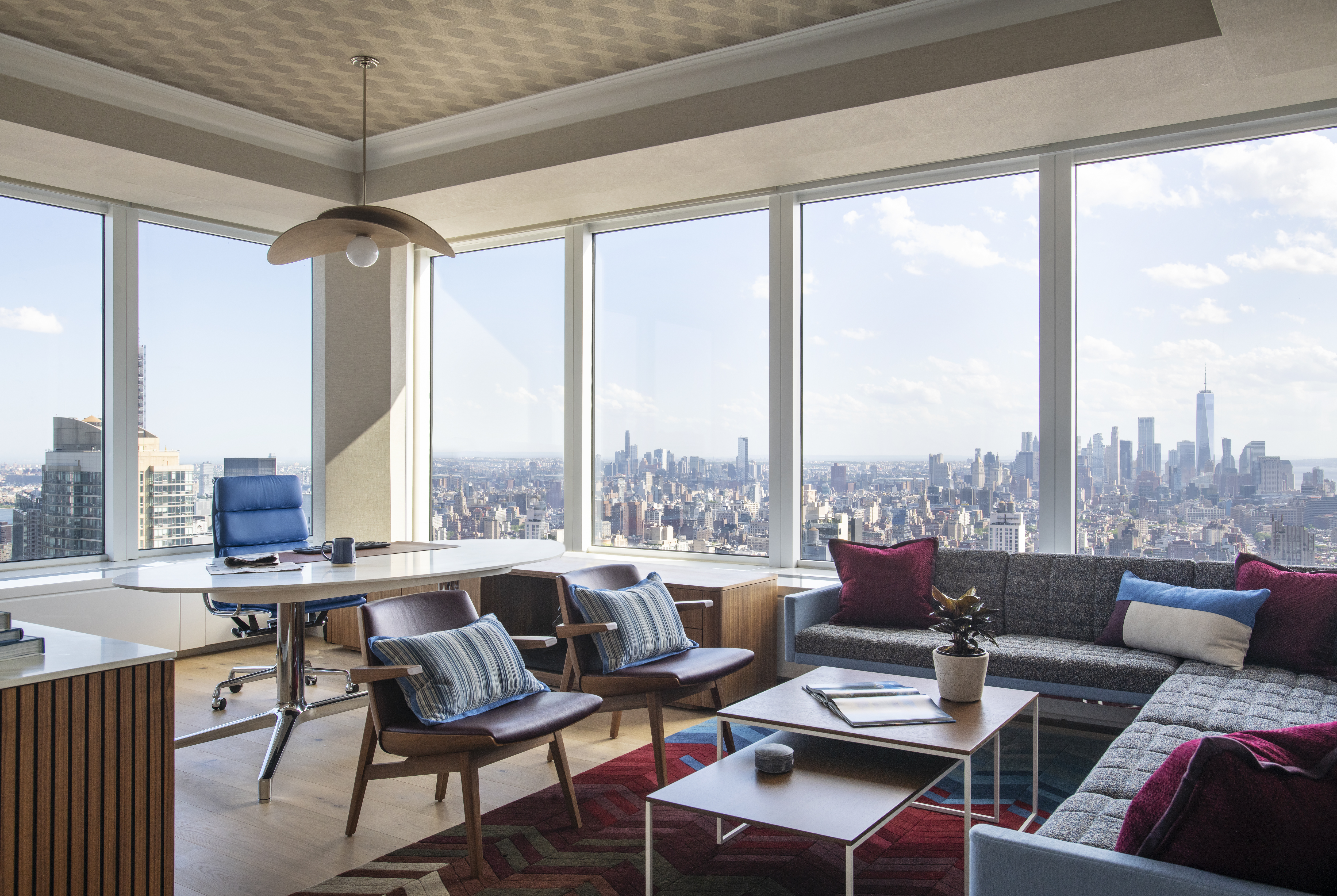 Luxury executive office at One Penn Plaza designed by K.A. Murphy Interiors with custom furnishings, layered textures, and expansive New York City skyline views.


